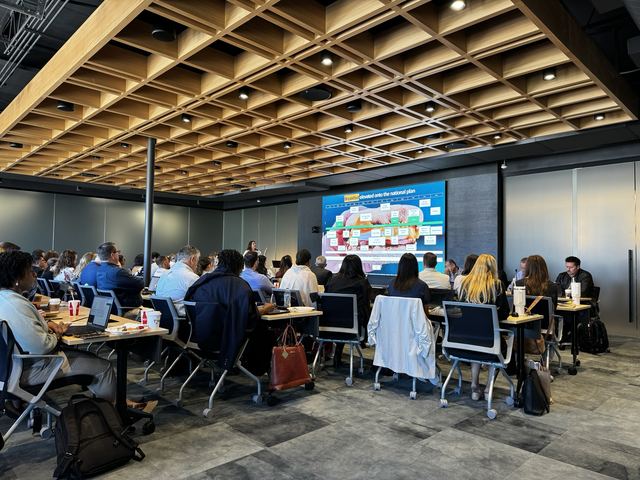 All-hands meeting in front of the LED wall
