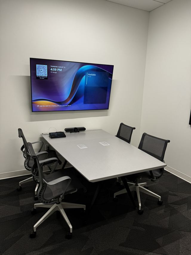 Small meeting room with display and scheduling panel